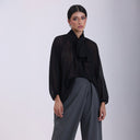 MIRA MIA black semi-sheer blouse with bow tie collar, long sleeves, and elegant dotted texture.