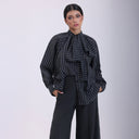 Black striped blouse with oversized bow and button-down front.